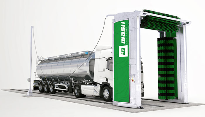 Vue 3D d'un portique de lavage ID WASH vert et d'un camion citerne sur piste de centre de lavage