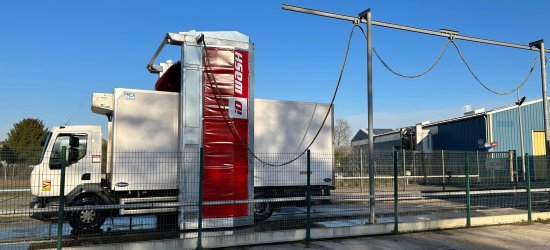 Station de lavage entrain d'effectuer le nettoyage extérieur d'un camion frigorifique